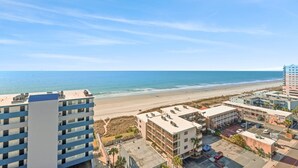 A coastal hotel with multiple buildings, a parking lot, and a beach view. - Perfect 3 bedroom condo, just across from the beach! | Malibu Pointe - 1105 (North Myrtle Beach)