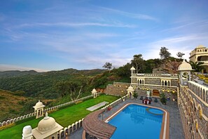 Outdoor pool, open 7:00 AM to 6:00 PM, pool loungers