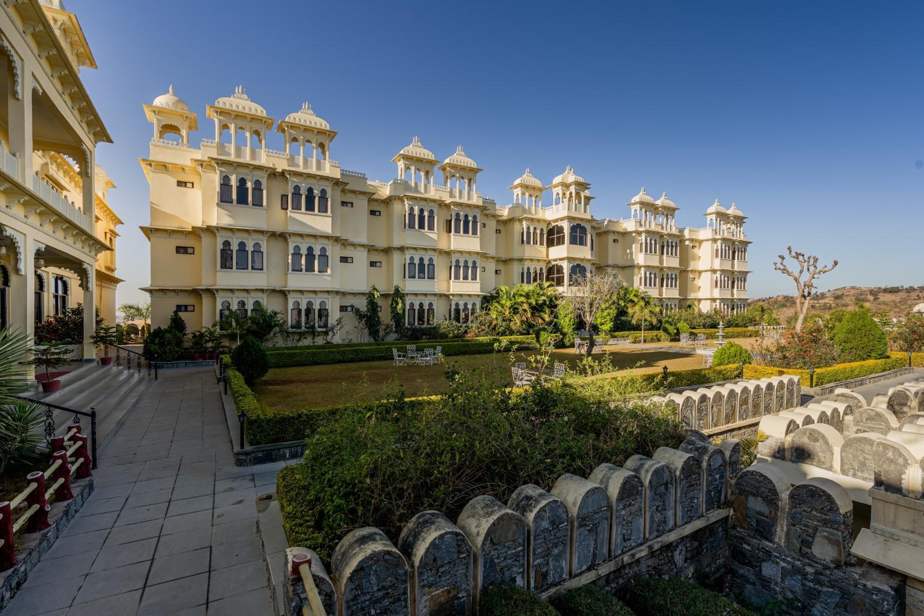 A large, multi-story building with traditional architecture, featuring multiple balconies and arched windows.
