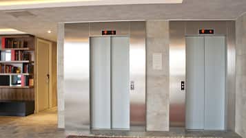 Two elevators with digital displays indicating floors 5 and 4.