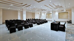 A conference room with rows of chairs, a table, and a projector screen. - Villa Le Palm - Luxury Resort Near Fateh Sagar Lake (3 KM) Udaipur (Udaipur)
