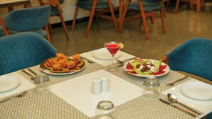 A dining table set with plates of food, cutlery, and a glass of red drink. - Villa Le Palm - Luxury Resort Near Fateh Sagar Lake (3 KM) Udaipur (Udaipur)