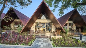 A modern building with a triangular roof and large glass windows. - Serendipity Lakes and Resorts (Tamia)