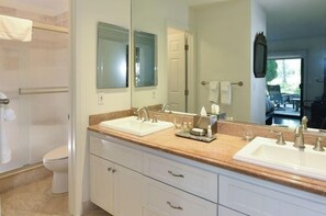 A bathroom with two sinks, a shower, and a large mirror. - 824 Oak Creek At Silverado 3 Bedroom Condo by RedAwning (Napa)