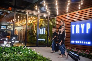 A modern building entrance with a large illuminated sign reading "TRYP" and a glass door entrance. - TRYP by Wyndham Santa Cruz (Santa Cruz)