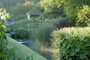 Escape to a serene oasis with a tranquil garden, a shaded gazebo, and a peaceful pond.