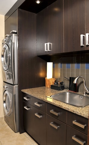Enjoy cooking in this well-equipped kitchen with a sink, faucet, and granite countertop.