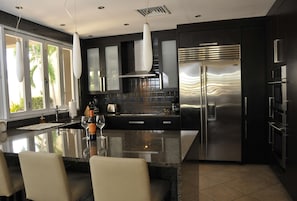Enjoy cooking in this well-lit kitchen with a large island, wine cooler, and high-end appliances.