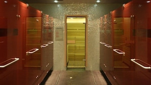 A hallway with a central elevator, flanked by glass-walled rooms with wooden floors and metal handrails. - Hotel Gozsdu Court Ex Gozsdu Court Apartment (Budapest)