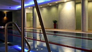 A swimming pool with clear lane markings, a metal handrail, and a potted plant in the background. - Hotel Gozsdu Court Ex Gozsdu Court Apartment (Budapest)