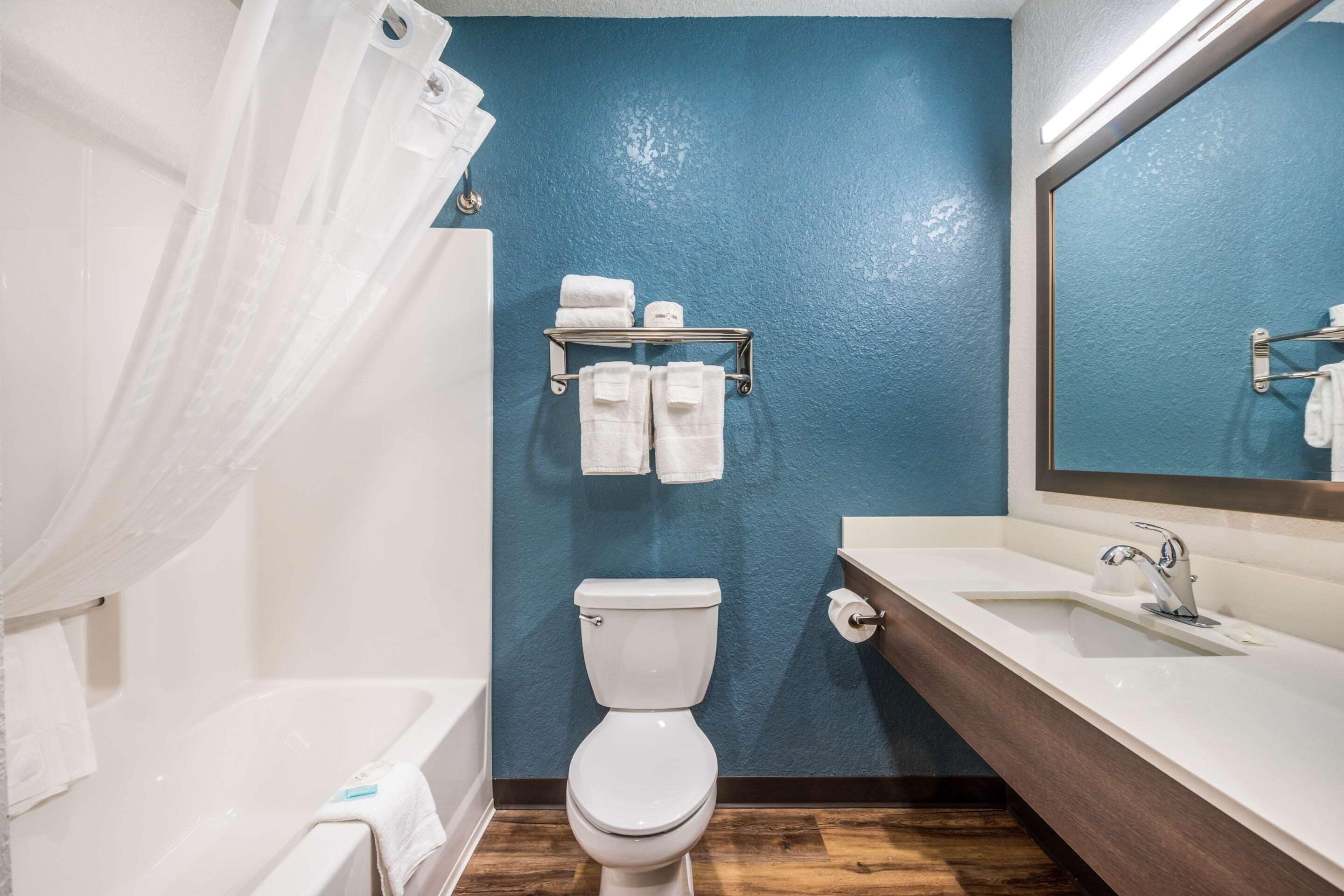 A bathroom with a bathtub, toilet, and sink.