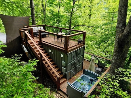Outdoor spa tub. Tiny Container Home Retreat with Hot Tub, Fire Table, Dining Area, and Views!