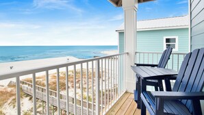 A balcony with a view of the beach and ocean. - Beachfront Luxury | Private Pool | Elevator (Gulf Shores)