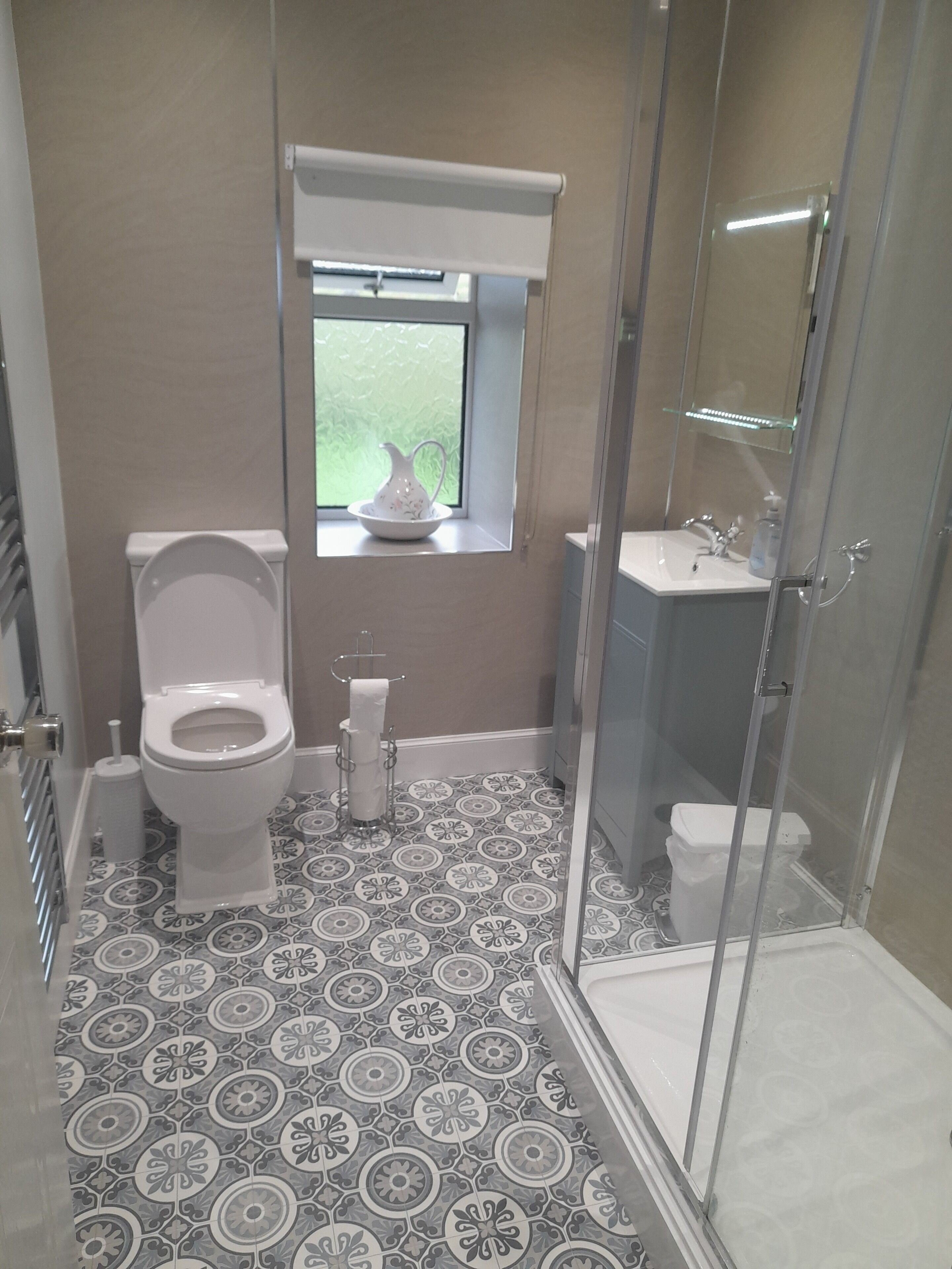 A bathroom with a toilet, bidet, and shower stall.