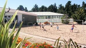 A sandy volleyball court with a greenhouse in the background. - Lovely apartment in villa for 4 guests with WIFI, pool, TV, terrace and pets allowed (Saint-hilaire-de-riez)