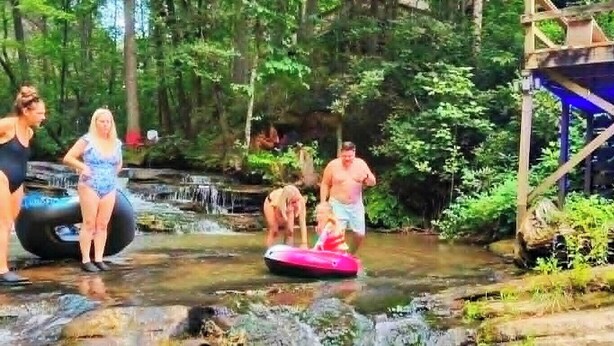A natural water feature with people engaging in water activities.