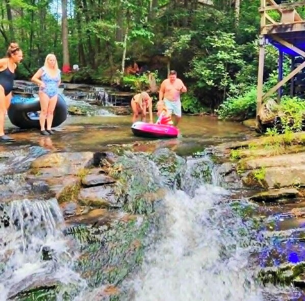 A natural water feature with people engaging in water activities.