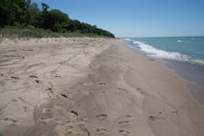 Enjoy a serene beach experience with gentle waves and lush surroundings.