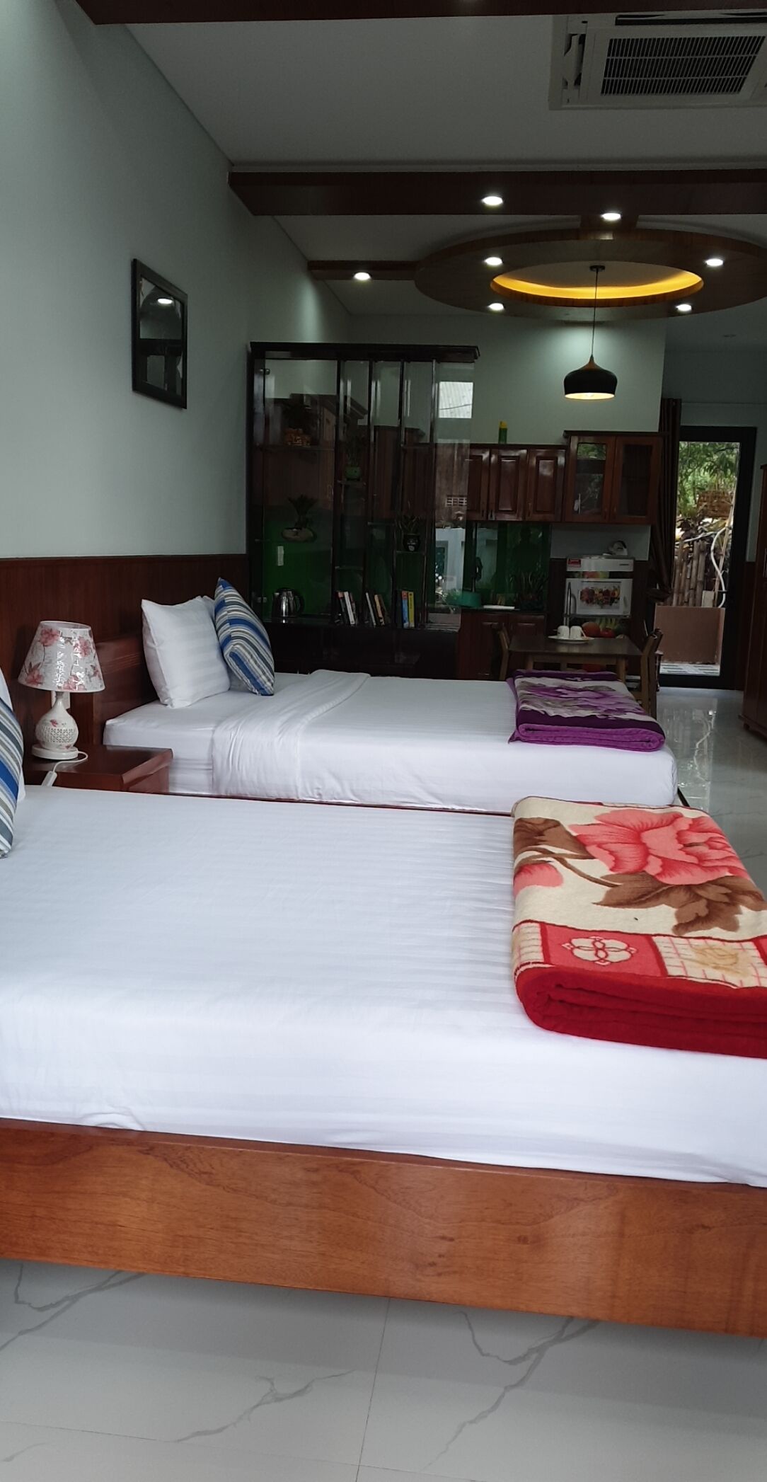A hotel room with two beds, a wooden headboard