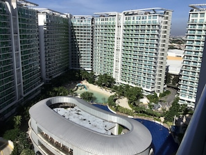Enjoy a tranquil retreat at our rooftop pool surrounded by lush greenery and a small beach area.