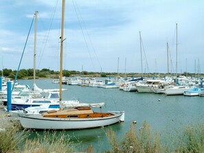 Guests can enjoy serene views of sailboats docked in calm waters surrounded by lush greenery.
