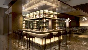 A modern bar area with a glass enclosure, bar stools, and a variety of bottles. - AC Hotel by Marriott Tokyo Ginza (Tokyo)