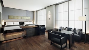 A modern hotel room with a bed, a desk, a sofa, and a large window. - AC Hotel by Marriott Tokyo Ginza (Tokyo)