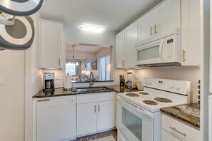 Enjoy cooking in this well-equipped kitchen with a microwave, stainless steel stove, and dishwasher.