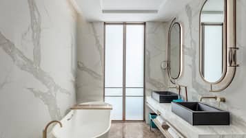 Separate tub and shower, designer toiletries, hair dryer, bathrobes