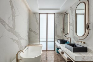 Separate tub and shower, designer toiletries, hair dryer, bathrobes