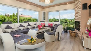 A modern living room with a sectional sofa, a glass coffee table, and a fireplace. - Wonderful private villa for 8 people with private pool, WIFI, A/C, TV and patio (Pazin)