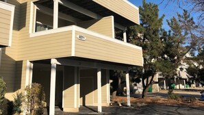 A multi-story building with a flat roof and a covered parking area. - The Pink Palace - Fenwick Island Beach Block w/ Pool & Super Easy Beach Access (Fenwick Island)