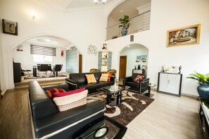 Relax in this stylish living area with a sofa set, coffee table, and dining space.