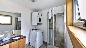 Premium Studio | Bathroom | Shower, hair dryer, towels, soap