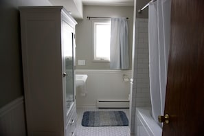 Combined shower/tub, hair dryer, towels, soap