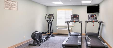 A fitness center with treadmills, an elliptical, and a stationary bike.