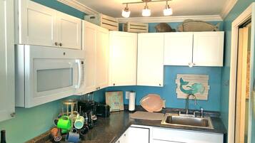 Fridge, microwave, stovetop, coffee/tea maker