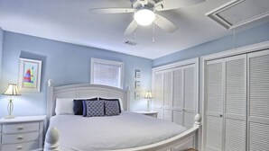 A bedroom with a bed, bedside tables, a ceiling fan, and a wardrobe. - Pet-Friendly | Steps to Beach & Old Town BSL! (Bay St. Louis)