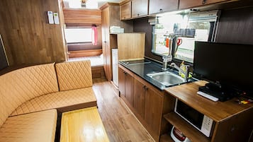 Caravan Healing | Living area | Flat-screen TV