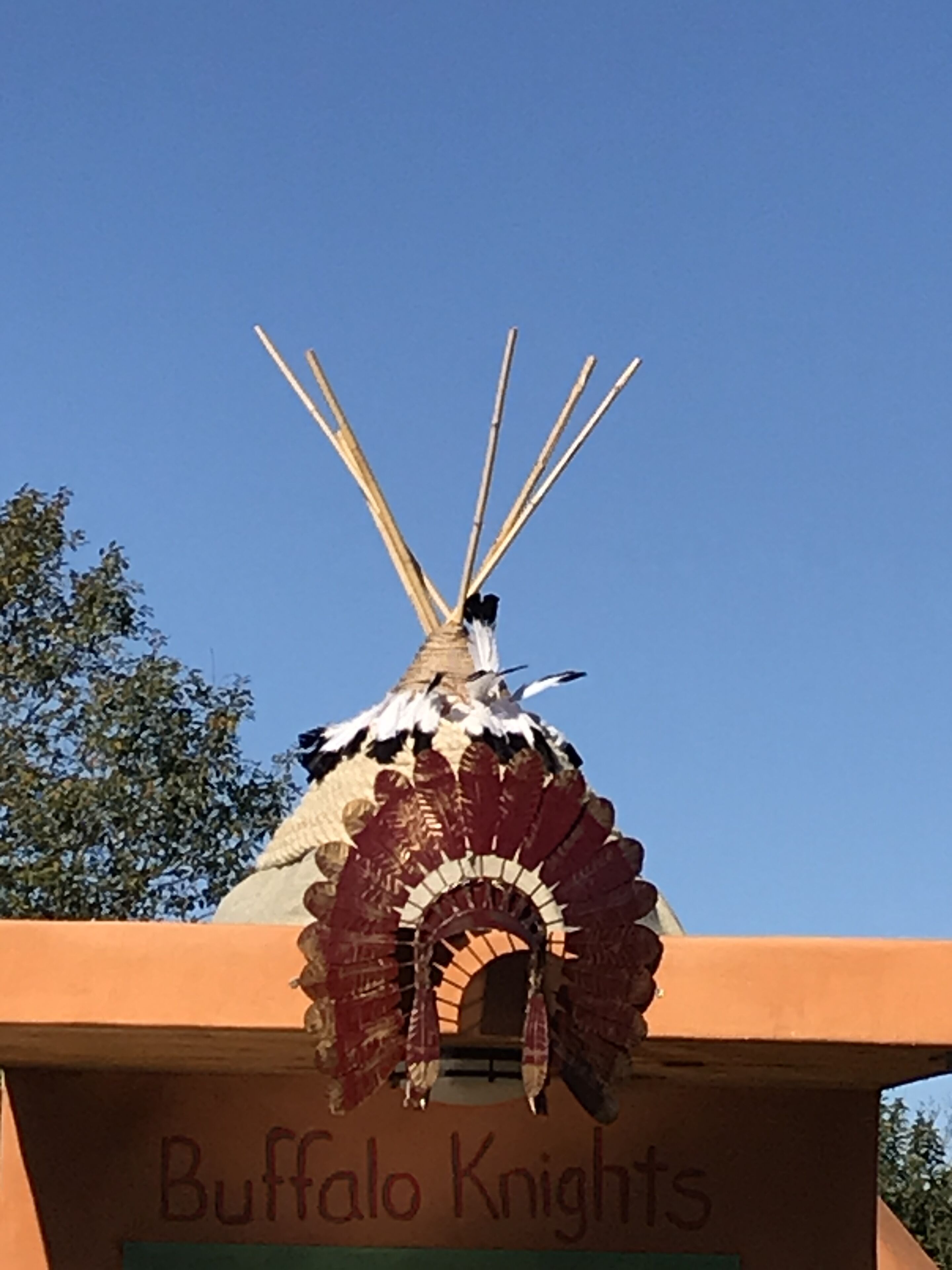 A teepee with a sign reading "Buffalo Knights" in front of it.