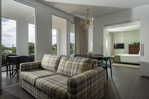 Junior Suite | Living area | 43-inch plasma TV with cable channels, TV, toys - Senhora da Rosa Tradition & Nature Hotel (Ponta Delgada)