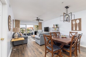 Cozy living space with a dining area, sofa, and TV.