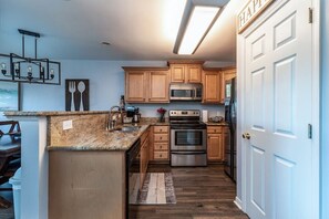 Enjoy cooking in this well-equipped kitchen with a central island, microwave, oven, and dishwasher.