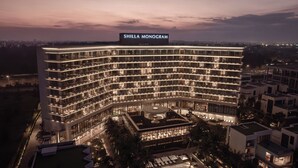 A multi-story hotel with a prominent sign reading "SHILLA MONOGRAM." It features a modern architectural design with a curved facade and multiple balconies. - Shilla Monogram Danang (Da Nang)