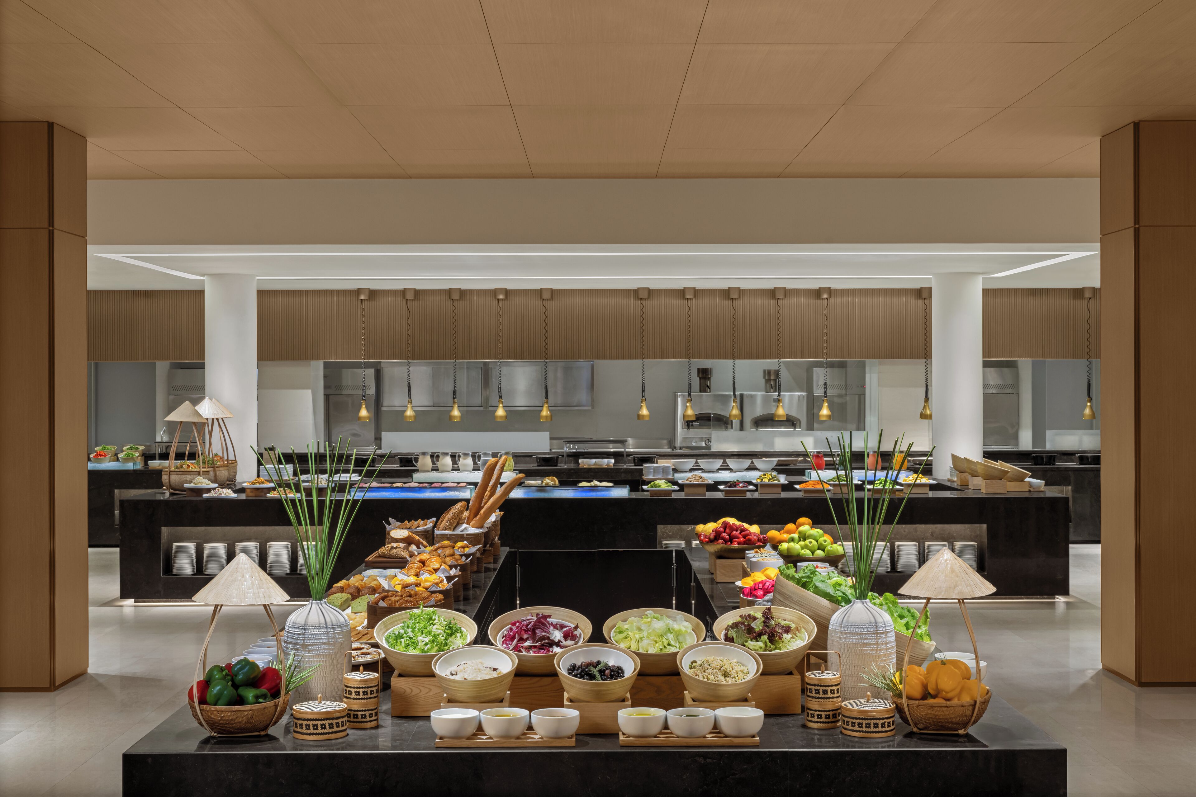 A buffet setup with various food items and bowls arranged on a counter.