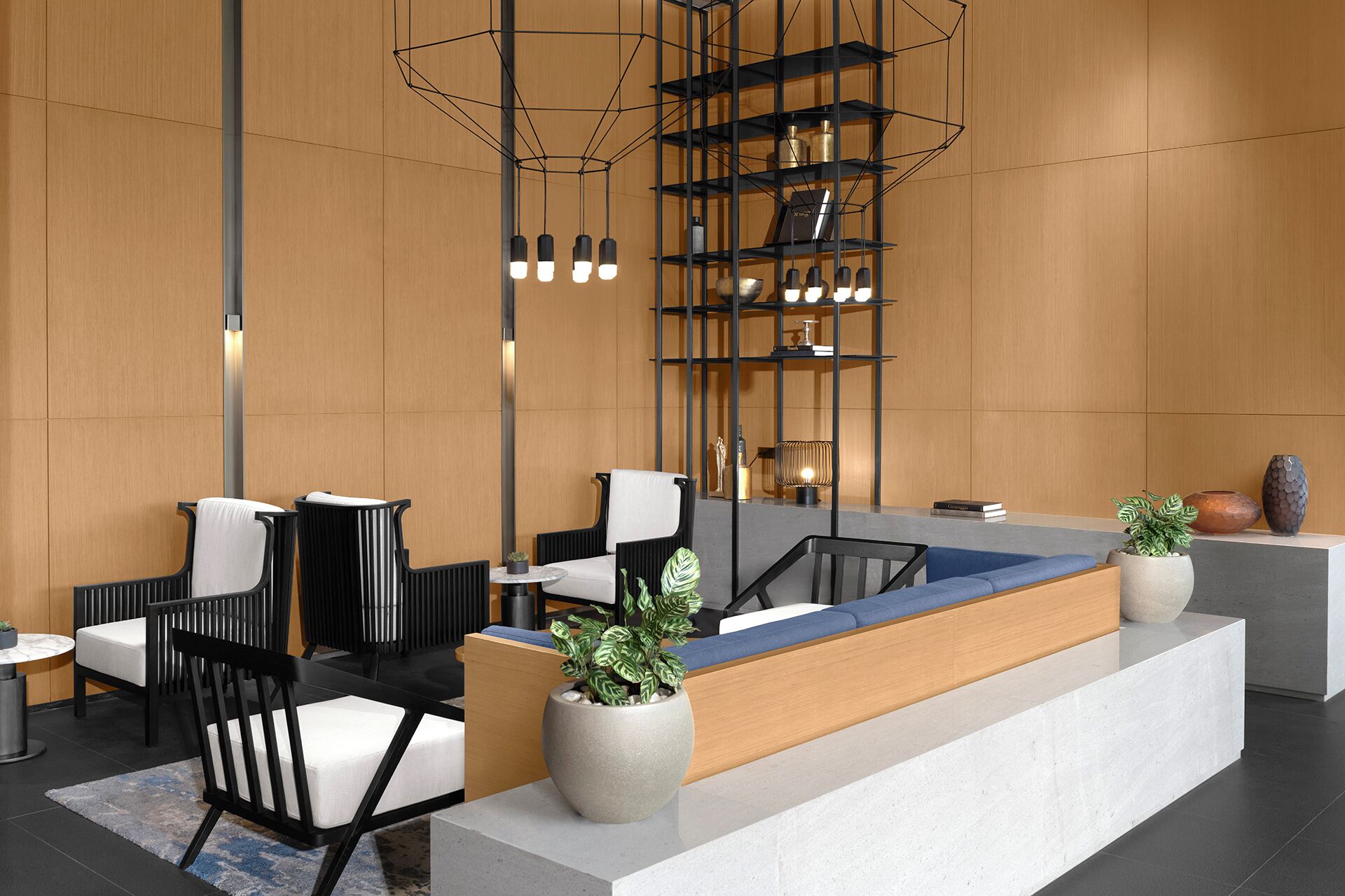 A modern reception area with a wooden reception desk, black and white chairs, and a geometric light fixture.