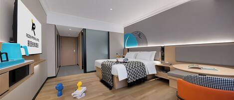 A modern hotel room with a bed, bedside table, chair, and a desk with a lamp.