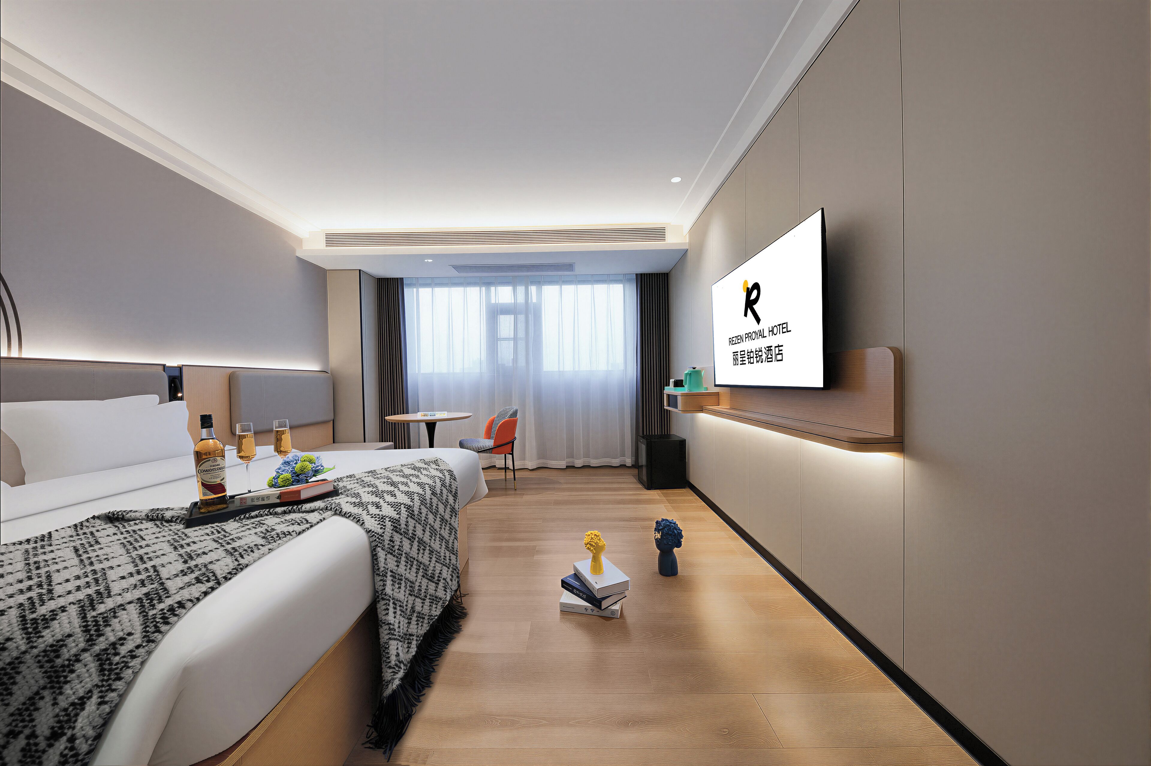 A modern hotel room with a bed, bedside table, TV, and a view of the city.