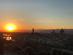 Stunning city views of a vibrant metropolis with a prominent cathedral and a serene body of water.