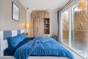 A modern bedroom with a large bed, built-in wooden wardrobe, and a sliding glass door to a balcony. - Place In Saigon (Ho Chi Minh City)